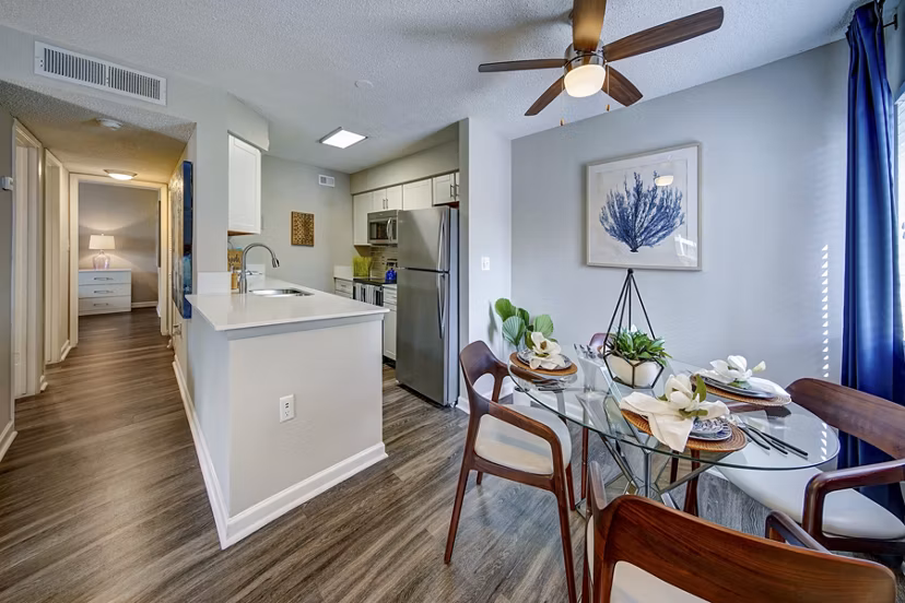 Dining area with modern decor at La Morada at Weston Apartments featuring elegant lighting and sleek furnishings