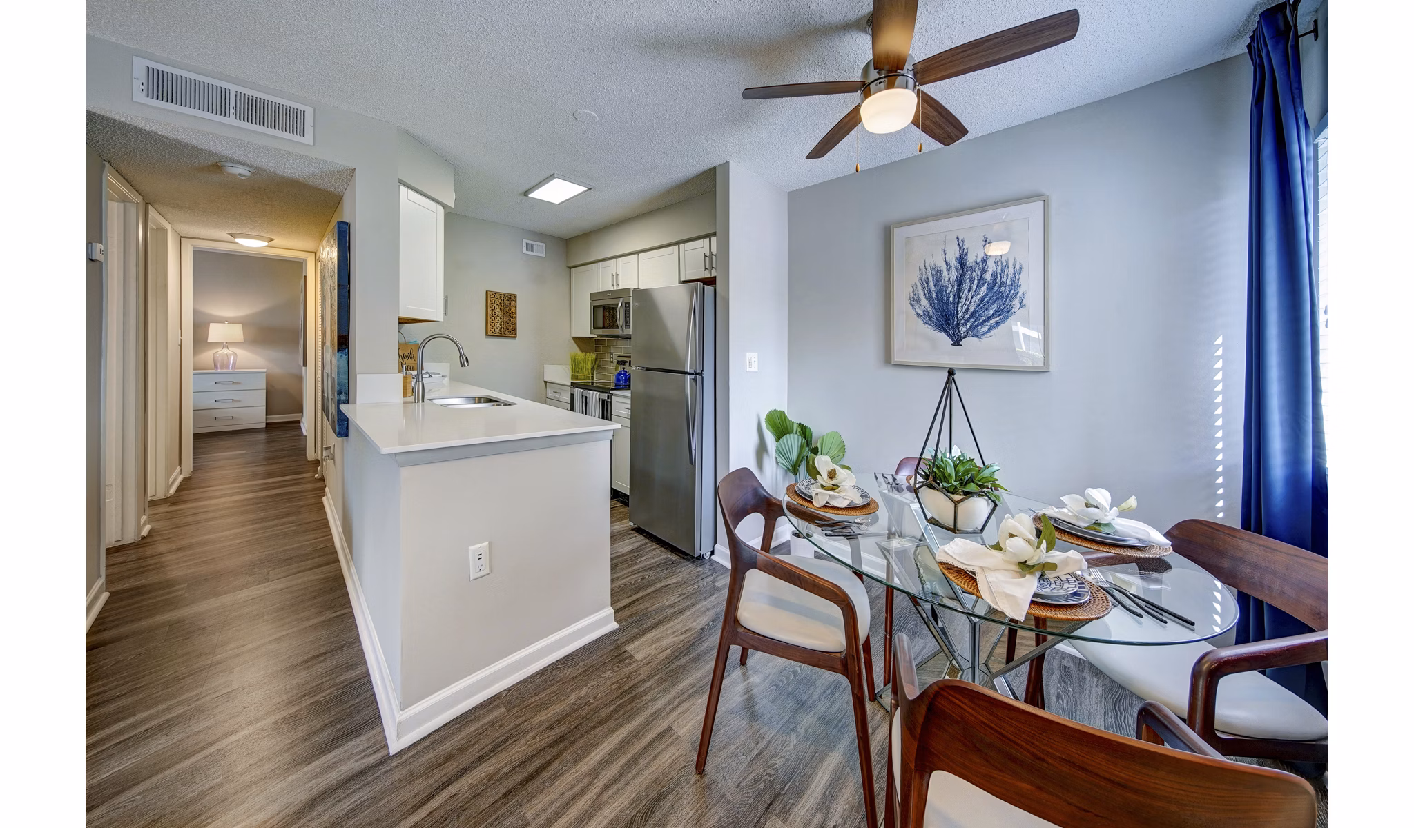 Dining area with modern decor at La Morada at Weston Apartments featuring elegant lighting and sleek furnishings