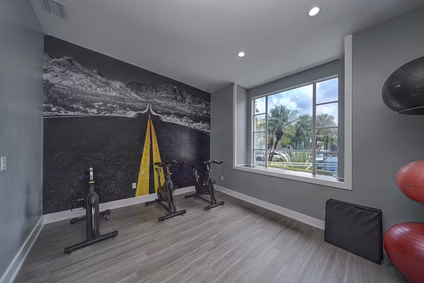 Modern fitness center equipped with state-of-the-art machines at La Morada at Weston Apartments