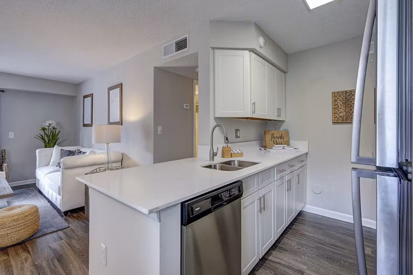 Kitchen featuring modern appliances and granite countertops in La Morada at Weston Apartments