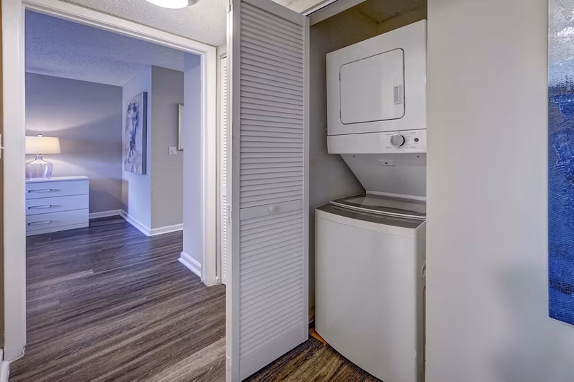Modern laundry room with high-efficiency machines at La Morada at Weston Apartments
