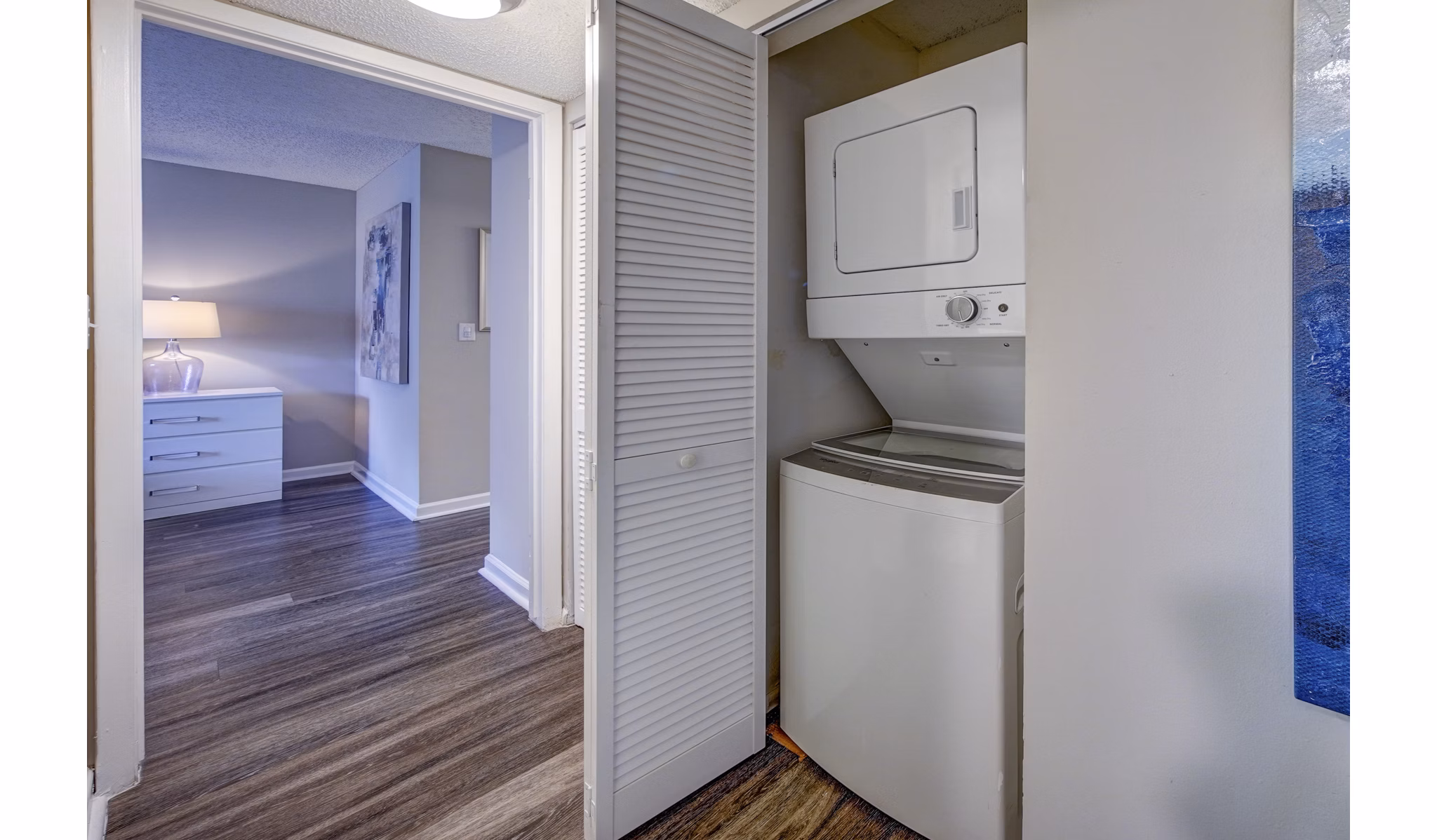 Modern laundry room with high-efficiency machines at La Morada at Weston Apartments