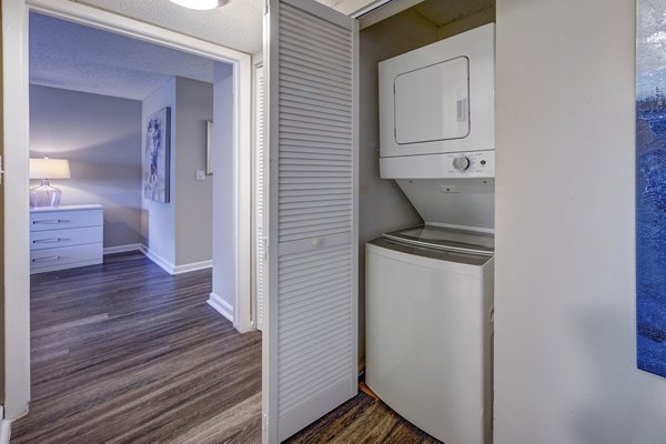 Modern laundry room with high-efficiency machines at La Morada at Weston Apartments