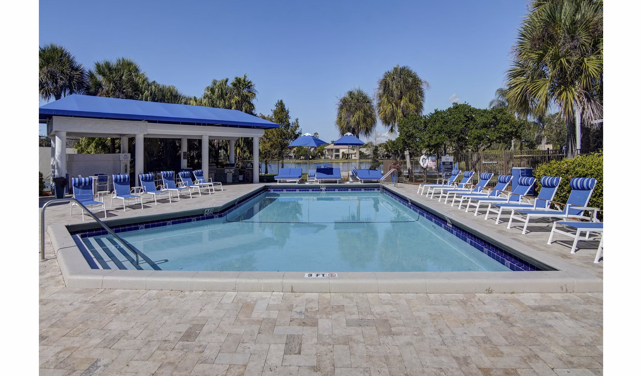 Serene pool with lounge chairs at La Morada at Weston Apartments, perfect for relaxation and leisure activities