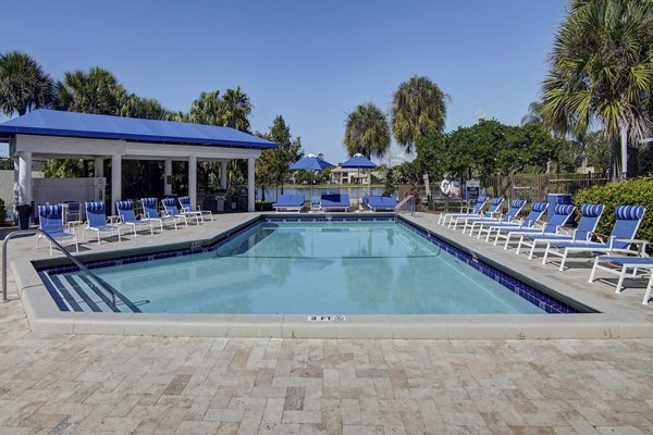 Serene pool with lounge chairs at La Morada at Weston Apartments, perfect for relaxation and leisure activities