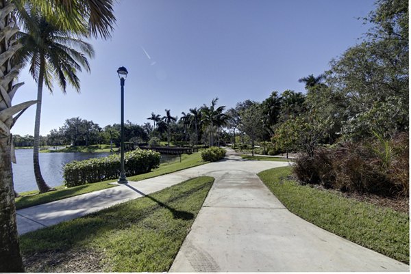 La Morada at Weston: Tranquil courtyard with lush gardens featuring outdoor seating for relaxation at luxury apartments