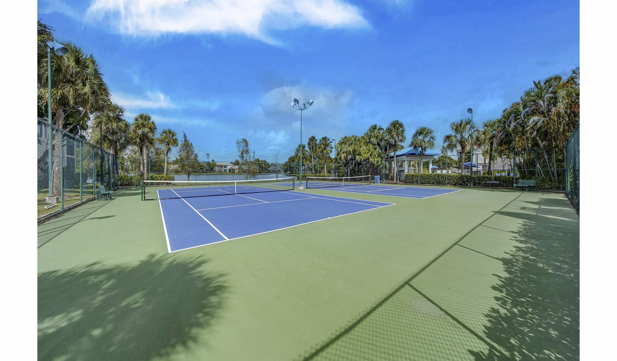 Sport court for basketball and tennis at La Morada at Weston Apartments featuring well-maintained facilities and lighting