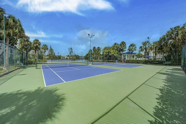 Sport court for basketball and tennis at La Morada at Weston Apartments featuring well-maintained facilities and lighting