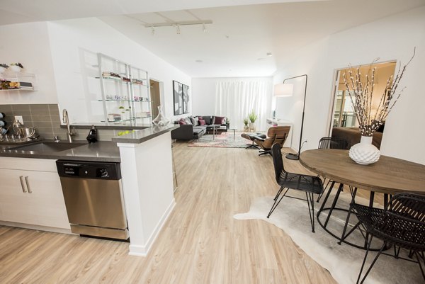 Dining room with elegant chandelier and modern furniture at ONYX Glendale Apartments