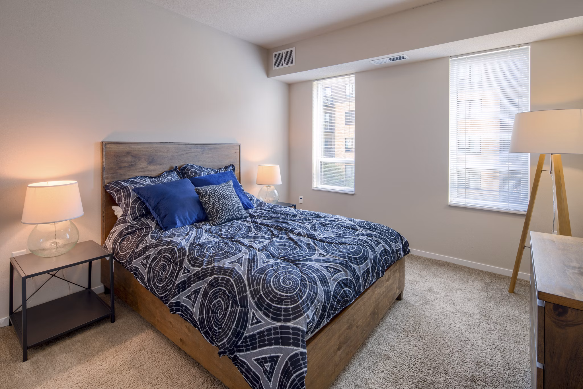 Cozy bedroom with modern decor and ample natural light at Grain Belt Apartments
