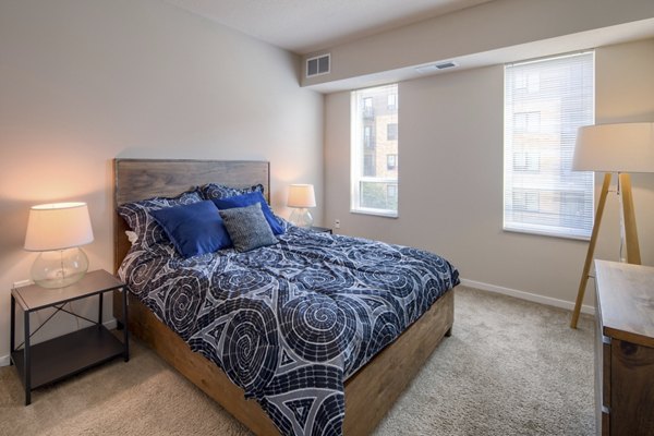 Cozy bedroom with modern decor and ample natural light at Grain Belt Apartments