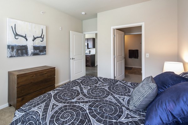 Bedroom with stylish decor and ample natural light in Grain Belt Apartments, a luxury living space offering modern comforts and elegance