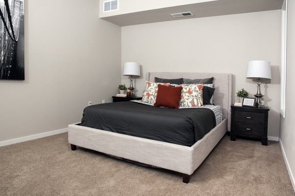Modern bedroom featuring stylish furnishings at Grain Belt Apartments, offering elegant design and comfort