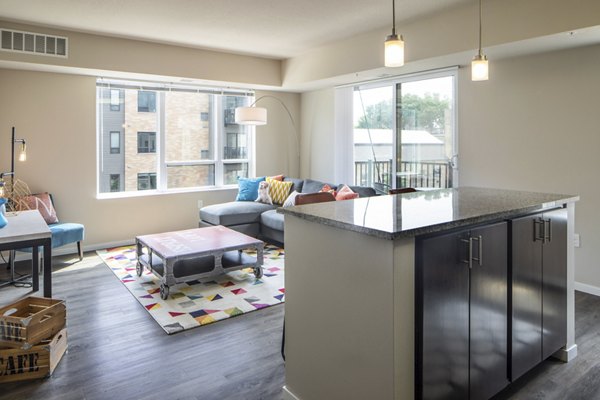 Open-concept kitchen with modern island at Grain Belt Apartments