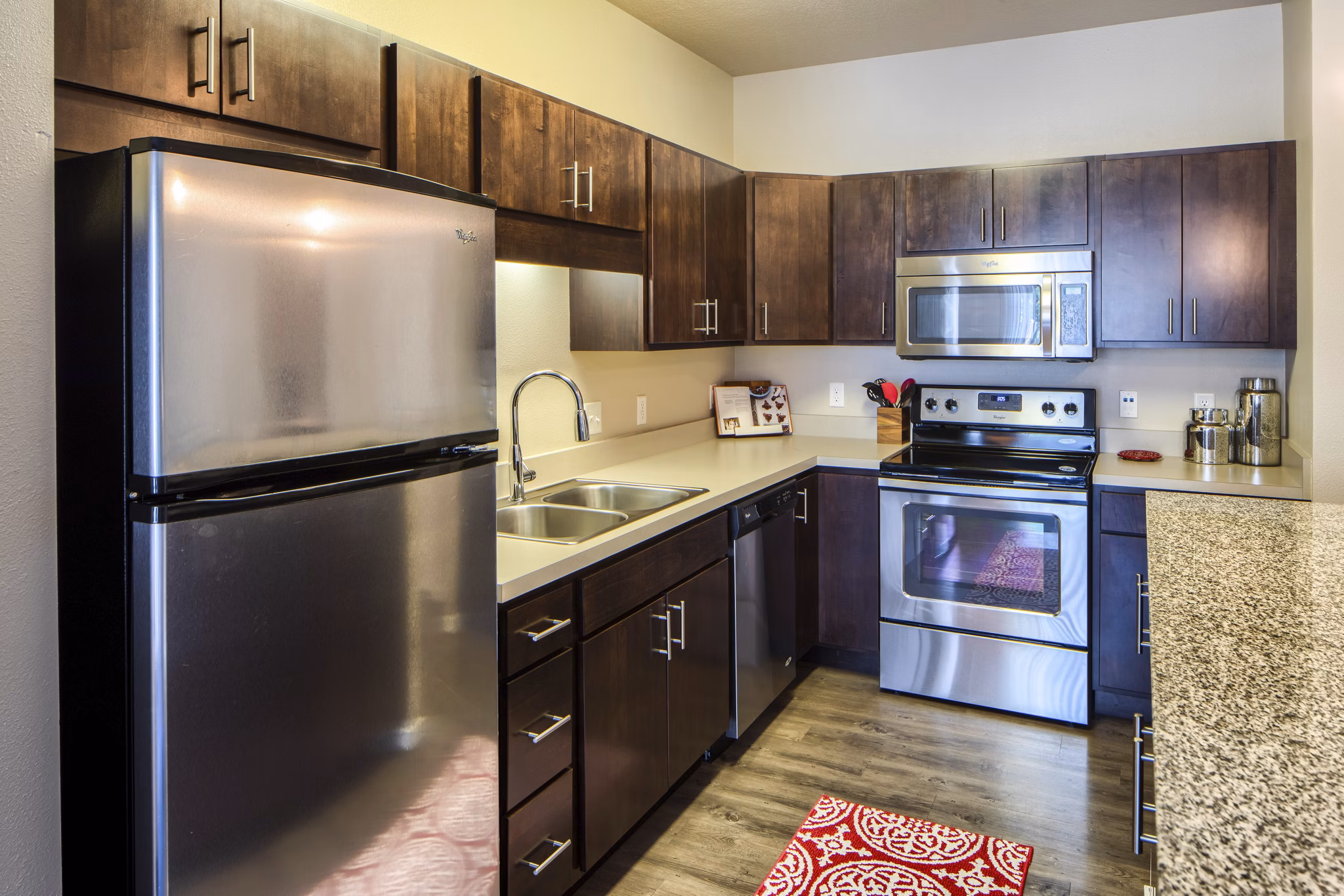 Modern kitchen with stainless steel appliances at Grain Belt Apartments, luxury living in a prime location