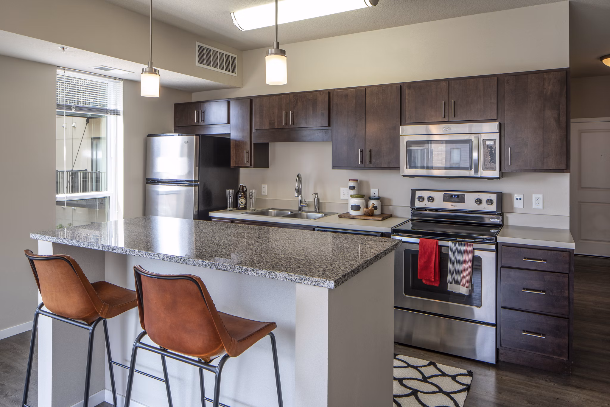 Modern kitchen with stainless steel appliances at Grain Belt Apartments