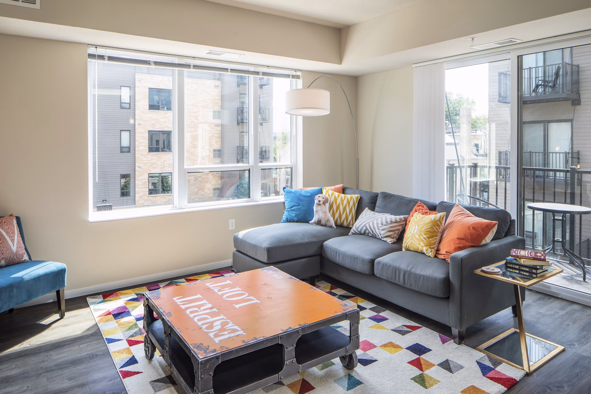 Spacious living room with modern furnishings and large windows in Grain Belt Apartments