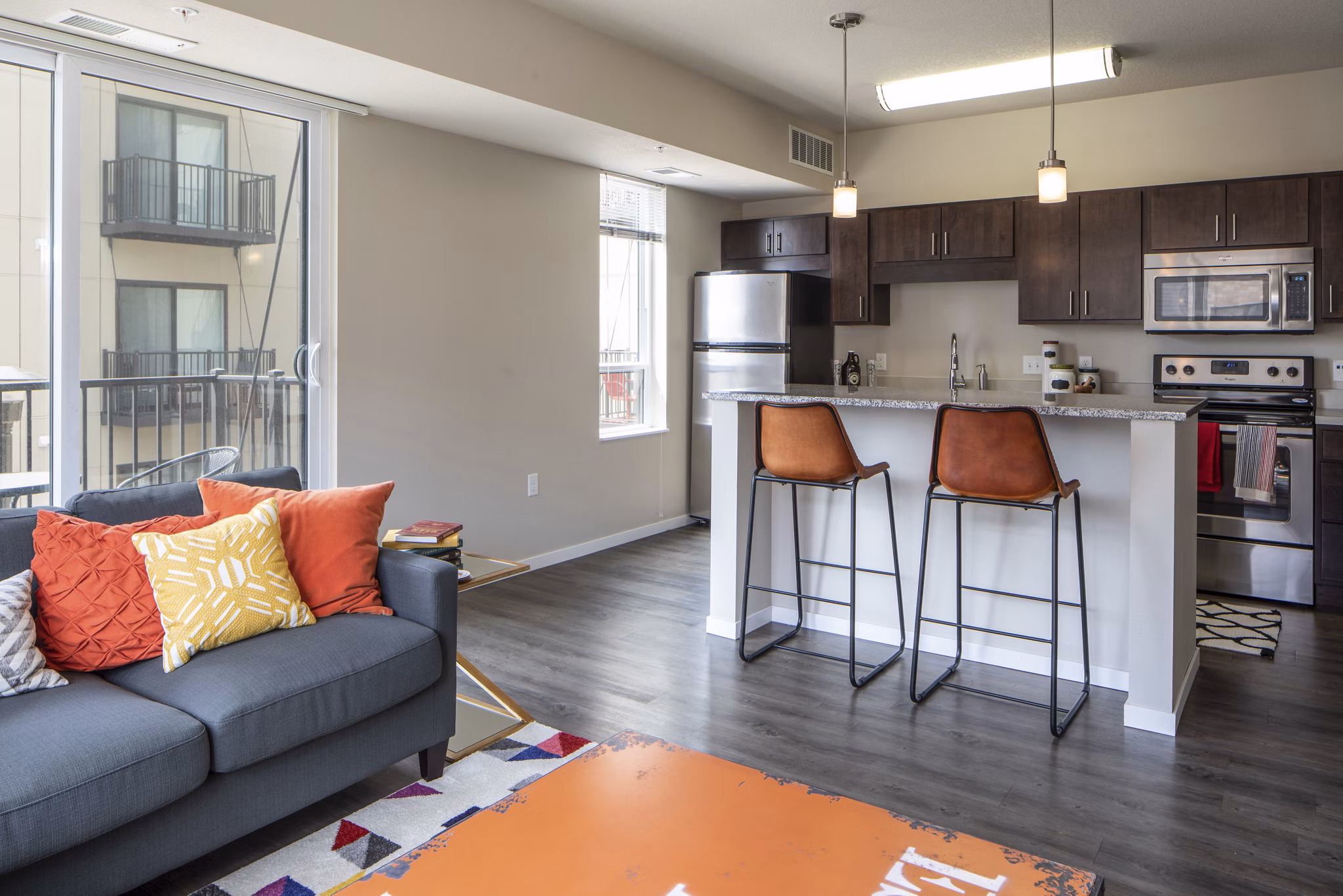 Spacious living room with modern decor and natural light at Grain Belt Apartments