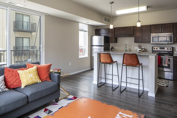 Spacious living room with modern decor and natural light at Grain Belt Apartments