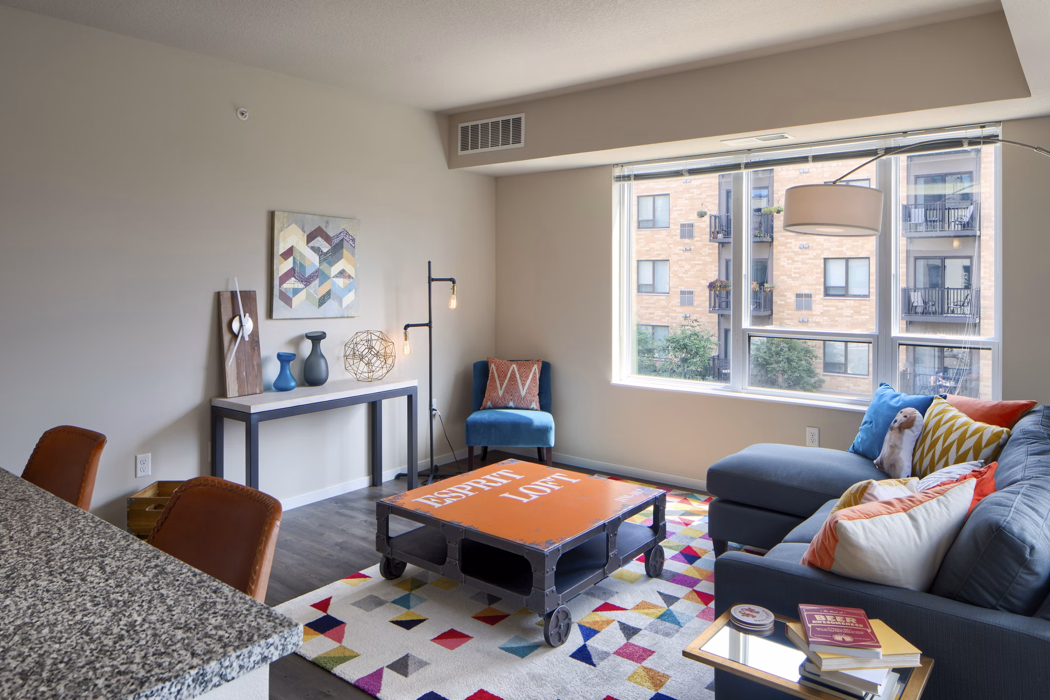 Open-concept living room with modern decor at Grain Belt Apartments, featuring comfortable seating and abundant natural light