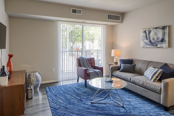 Spacious living room with modern decor and large windows in Grain Belt Apartments