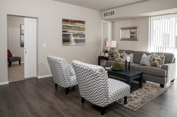 Spacious living room with modern decor at Grain Belt Apartments, featuring comfortable seating and large windows for natural light