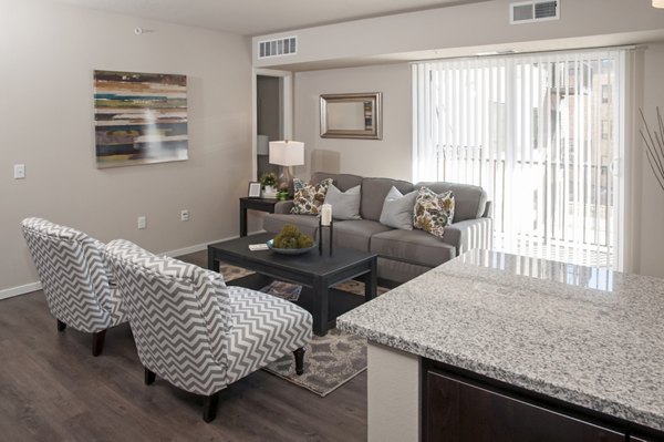 Spacious living room with modern furnishings and large windows at Grain Belt Apartments luxury space