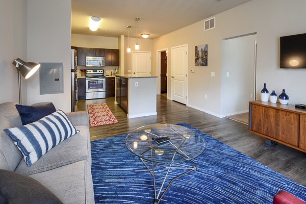Spacious living room with modern decor in Grain Belt Apartments, offering luxury urban living