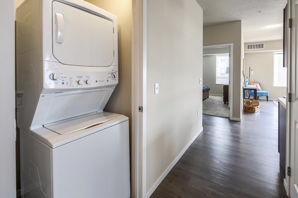 Laundry room with modern appliances at Grain Belt Apartments