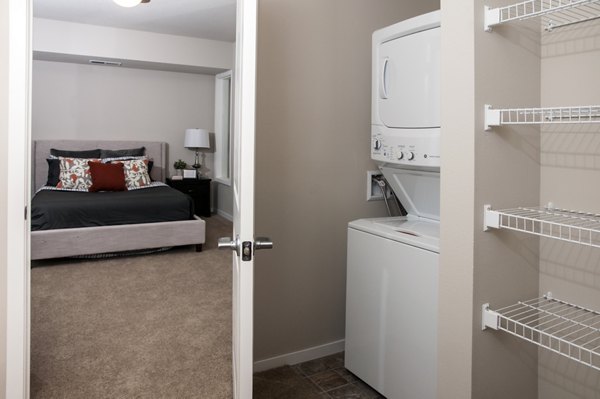 Laundry room with high-efficiency washers and dryers at Grain Belt Apartments