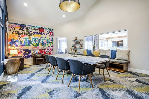 Meeting room featuring modern seating and presentation equipment at Avana Sunnyvale Apartments