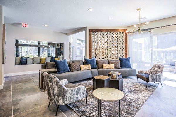 Avana Sunnyvale Apartments: Clubhouse lobby featuring modern design and seating areas for community gatherings