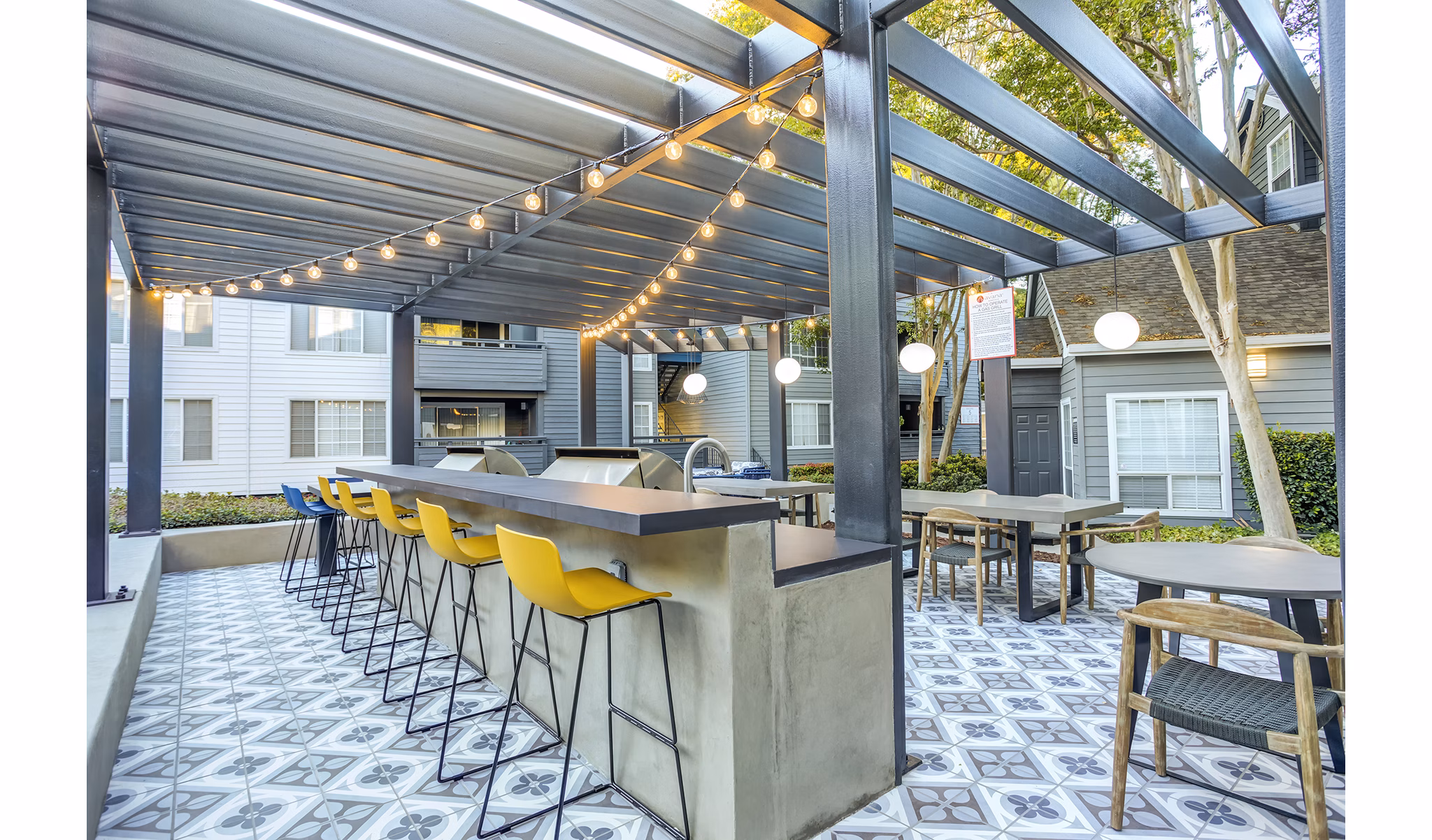 Outdoor grill area with modern seating at Avana Sunnyvale Apartments, ideal for gatherings and entertaining in a luxurious setting