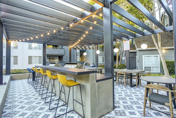Outdoor grill area with modern seating at Avana Sunnyvale Apartments, ideal for gatherings and entertaining in a luxurious setting