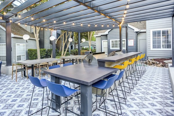 Outdoor grilling area with modern BBQ setup at Avana Sunnyvale Apartments
