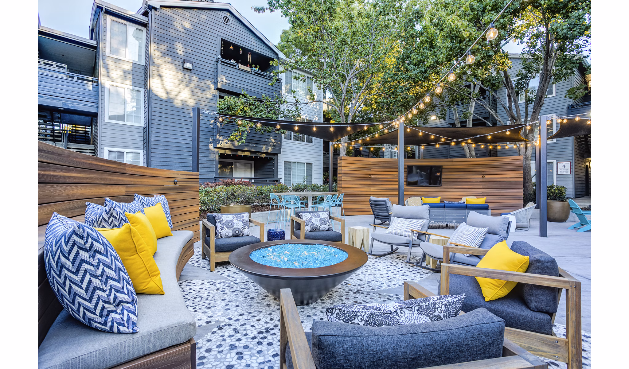 Cozy outdoor patio with fire pit at Avana Sunnyvale Apartments, offering a luxurious relaxation space in beautiful surroundings