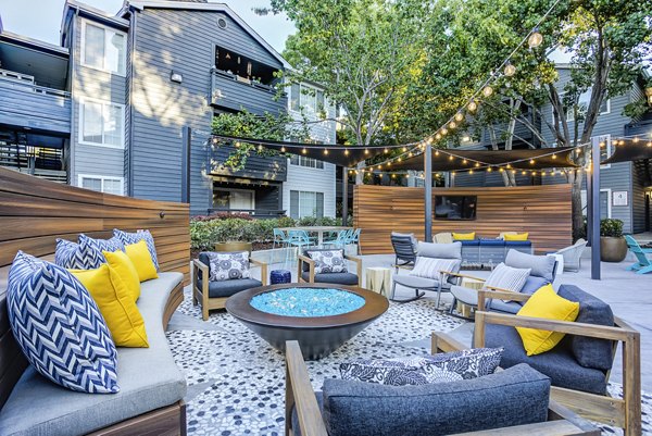 Cozy outdoor patio with fire pit at Avana Sunnyvale Apartments, offering a luxurious relaxation space in beautiful surroundings