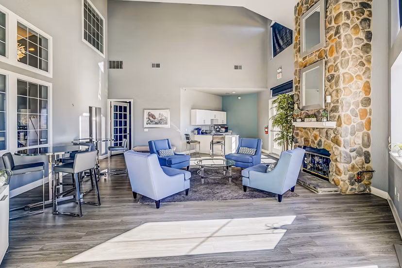 Clubhouse lobby with modern decor and seating at Commons at Briargate Apartments