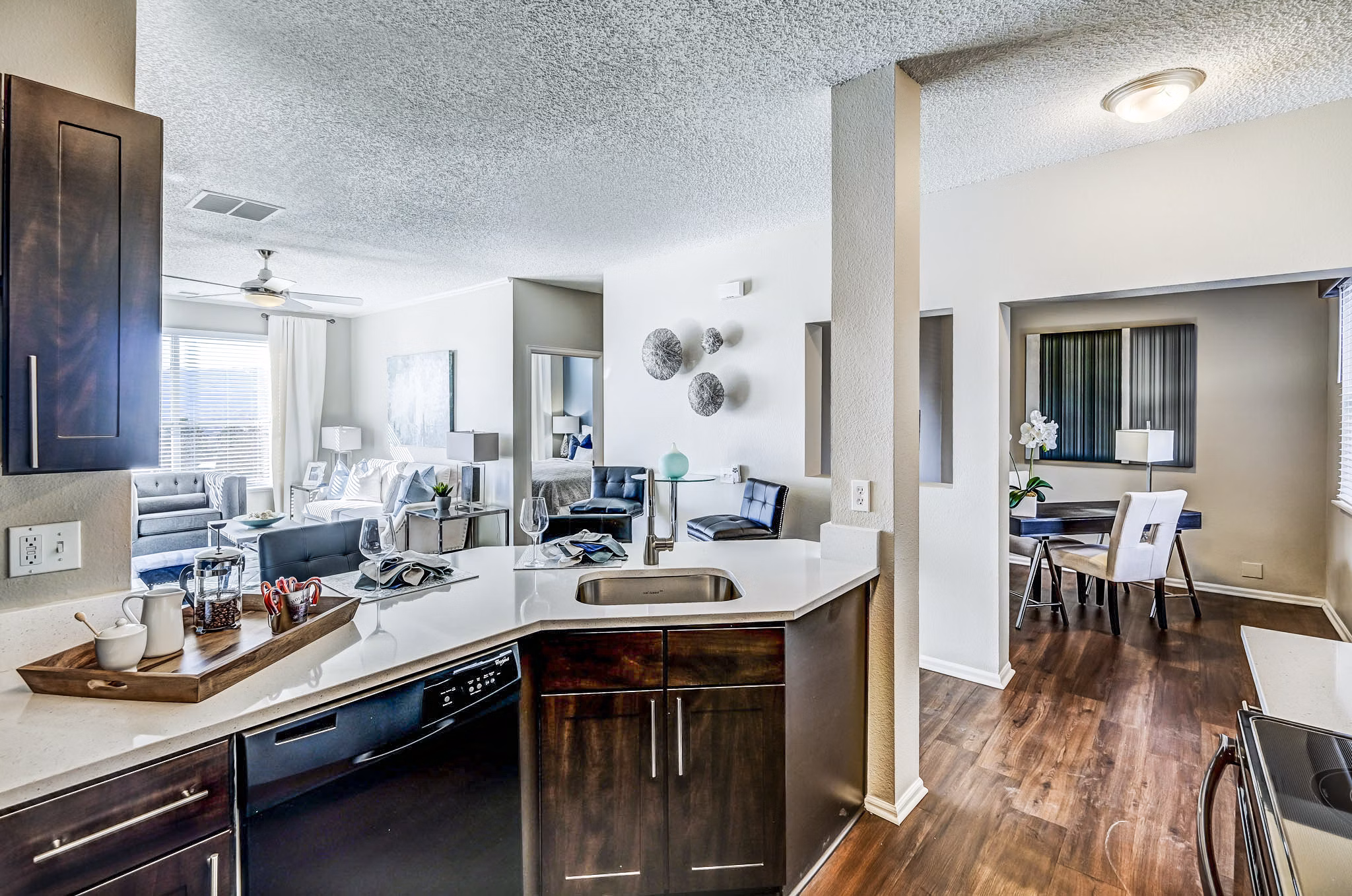 Modern kitchen with sleek countertops and stainless steel appliances at Commons at Briargate Apartments