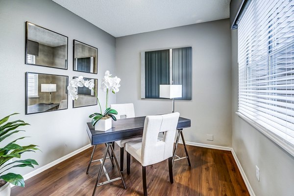 Home office with ergonomic desk and modern decor at Commons at Briargate Apartments, offering a productive workspace in luxury apartment setting