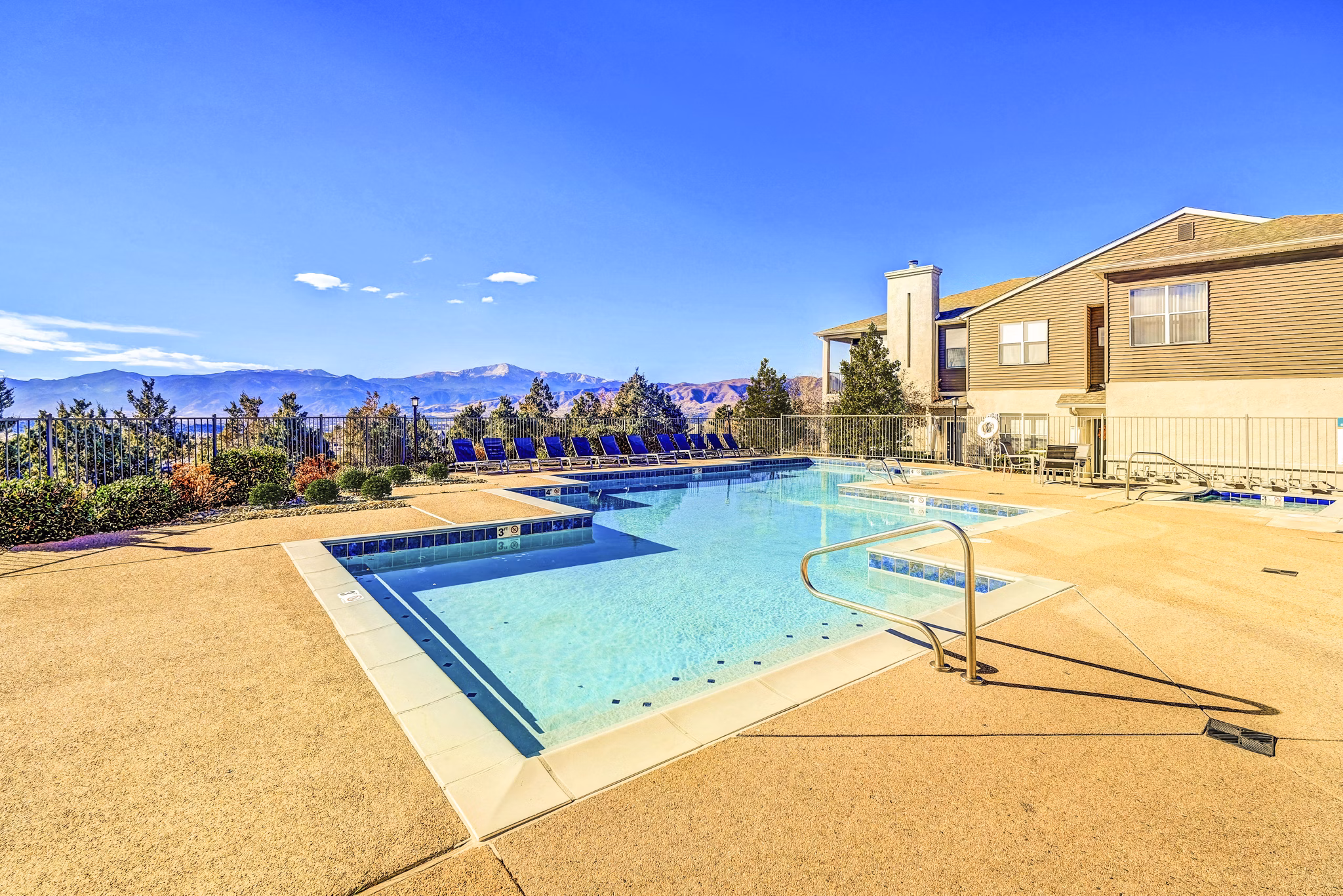 Resort-style pool with sun loungers at Commons at Briargate Apartments in Colorado Springs