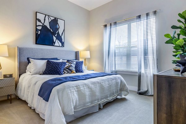 Luxurious bedroom with elegant decor at Overture Providence Apartments, perfect for upscale living in a serene environment