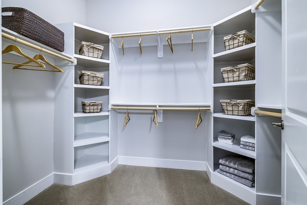 Walk-in closet with ample shelving in Overture Providence Apartments