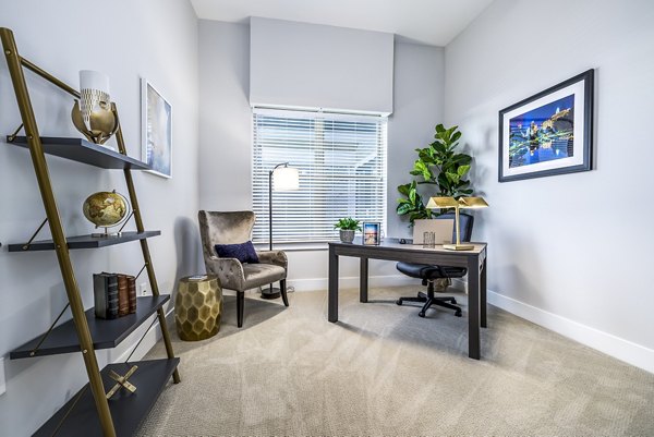 Home office with modern desk and ergonomic chair at Overture Providence Apartments