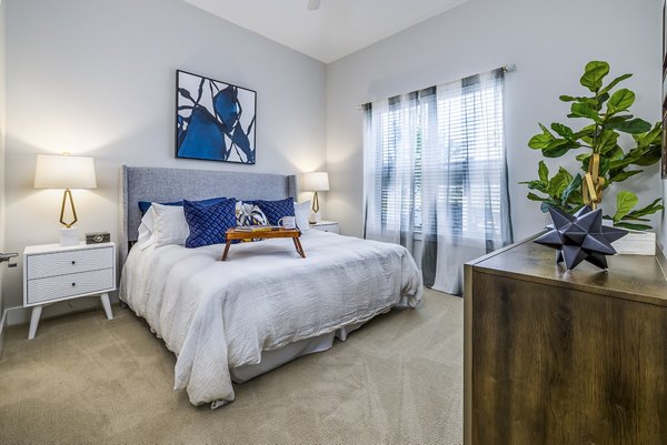 Spacious bedroom with elegant decor at Overture Providence luxury apartments, offering comfort and style for residents