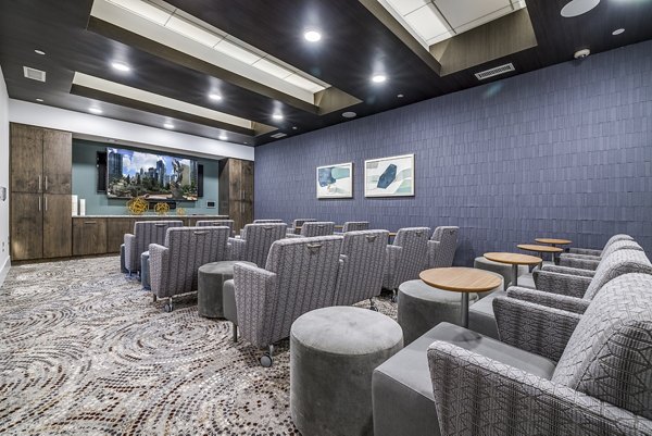 Theater with plush seating and large screen at Overture Providence Apartments