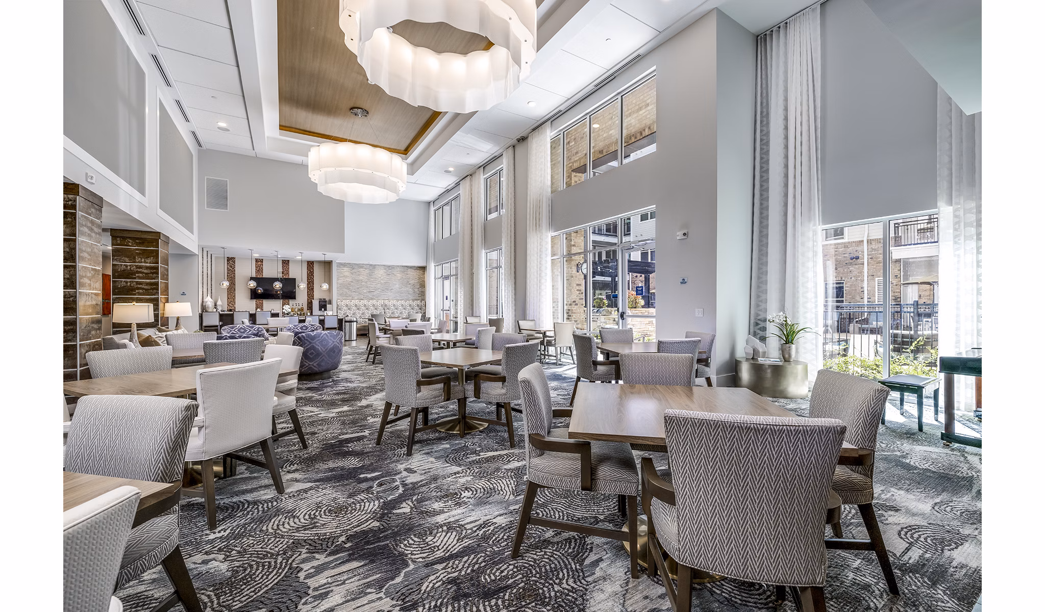 Clubhouse lobby featuring modern design and cozy seating at Overture Providence Apartments, ideal for social gatherings and relaxation