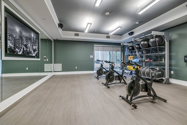 Yoga and spin studio with modern equipment at Overture Providence Apartments, ideal for fitness enthusiasts seeking a luxury lifestyle