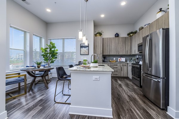 Modern kitchen featuring stainless steel appliances and granite countertops at Overture Providence Apartments