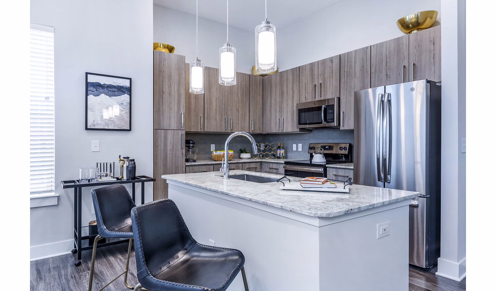 Modern kitchen with sleek appliances and granite countertops in Overture Providence Apartments